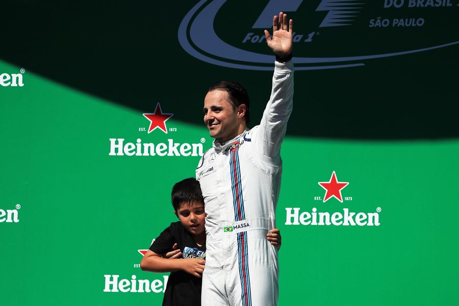Felipe Massa celebrates the finish of his last race on the podium with his son Felipinho Massa