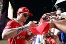 Kimi Raikkonensigns autographs for the fans