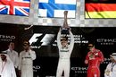 Race winner Valtteri Bottas celebrates on the podium with the trophy alongside Lewis Hamilton and Sebastian Vettel