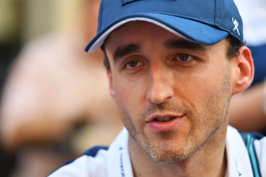 Robert Kubica talks with media after the session