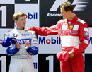 Michael Schumacher consoles brother Ralf on the podium after a closely fought French Grand Prix
