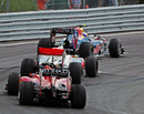 Mark Webber leads Lewis Hamilton and Fernando Alonso out of the hairpin