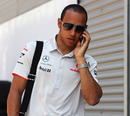 Lewis Hamilton takes a call in the Valencia paddock