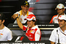 Vitaly Petrov shakes the hand of Fernando Alonso during Thursday's press conference