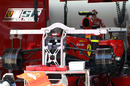 Mechanis work on the rear of Fernando Alonso's Ferrari
