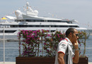 Lewis Hamilton takes a call in front of Vijay Mallya's boat, Indian Empress