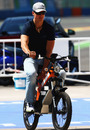 Michael Schumacher on his paddock moped