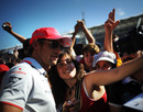 Jenson Button has his photo taken with a fan