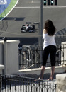 A spectator watches Michael Schumacher during practice