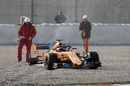 Fernando Alonso in the gravel with missing rear wheel