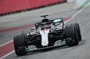 Lewis Hamiltonin powers down the pit lane in the Mercedes