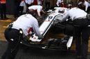 Sauber mechanics wheel Marcus Ericsson back into the garage