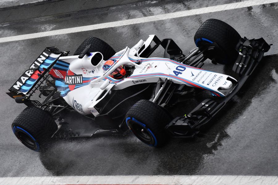 Robert Kubica powers down the pit lane in the Williams