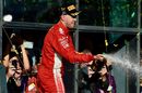 Race winner Sebastian Vettel celebrates on the podium with the champagne
