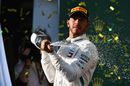 Lewis Hamilton celebrates on the podium with the champagne