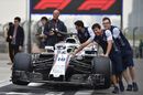Williams mechanics with Williams FW41 in pit lane