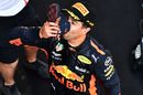 Race winner Daniel Ricciardo celebrates with a shoey on the podium