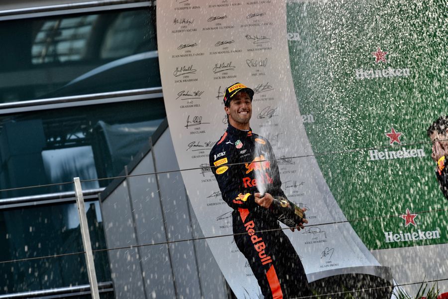 Race winner Daniel Ricciardo celebrates on the podium with the champagne