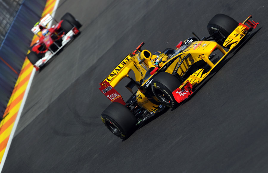 Renault's Robert Kubica leads Fernando Alonso's Ferrari