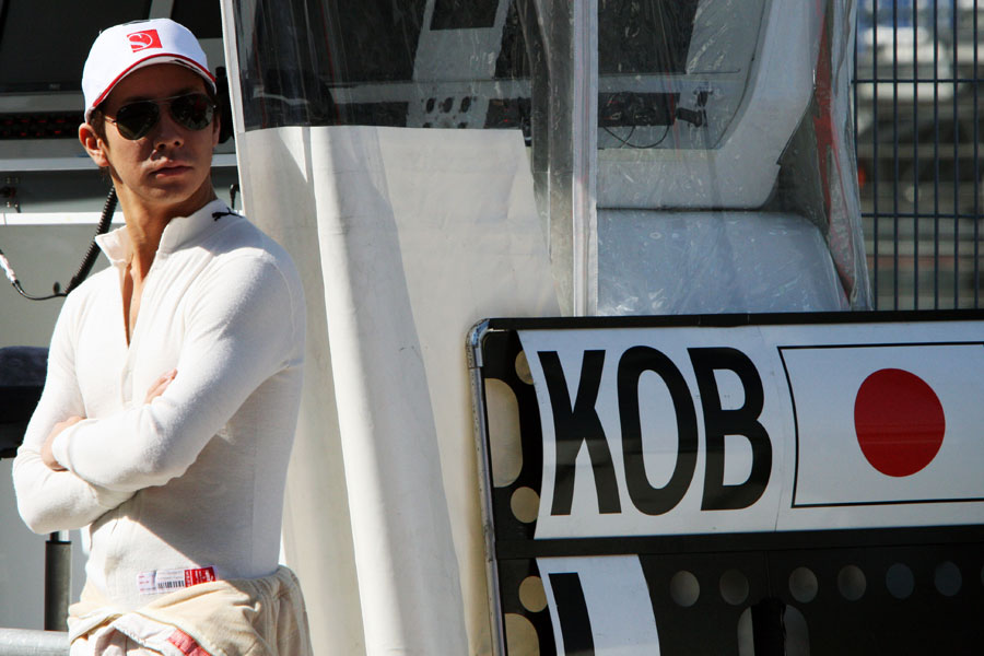 Kamui Kobayashi looks on during practice