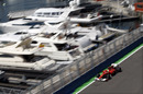 Felipe Massa powers past the boats in the harbour