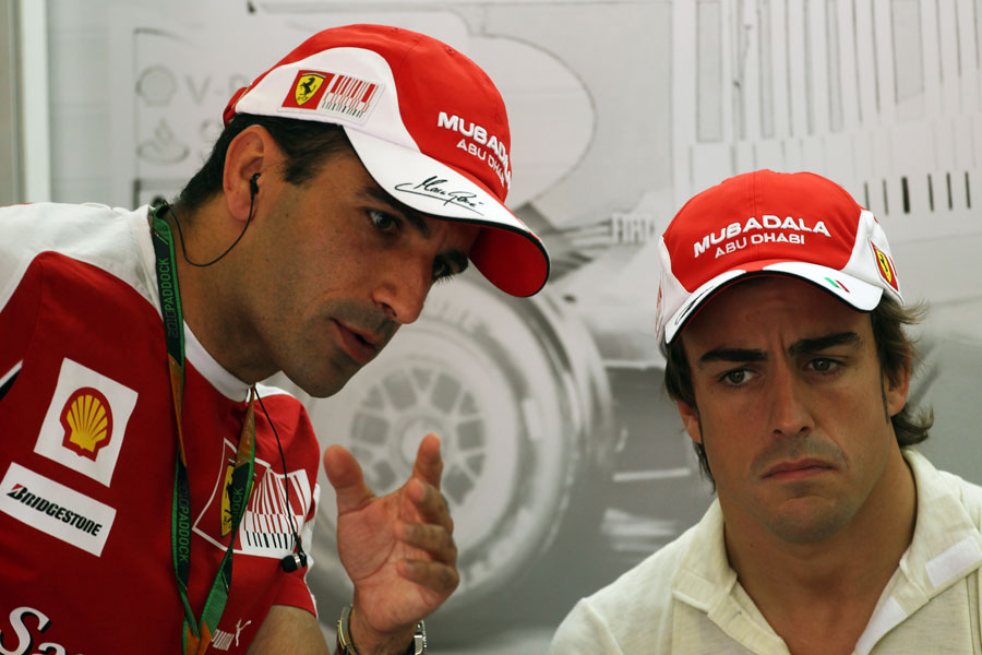 Test driver Marc Gene talks to Fernando Alonso