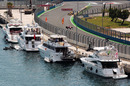 Fernando Alonso and Robert Kubica drive past boats in the harbour