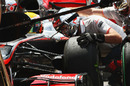 Mechanics change tyres on Lewis Hamilton's McLaren