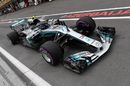 Valtteri Bottas powers down the pit lane in the Mercedes