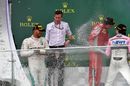 Lewis Hamilton, Kimi Raikkonen and Sergio Perez celebrate on the podium with the champagne