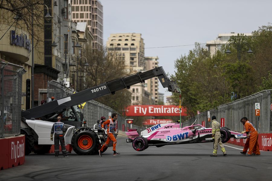 The crashed car of Esteban Ocon is recovered