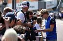 Brendon Hartley signs autographs for fans in the pit lane