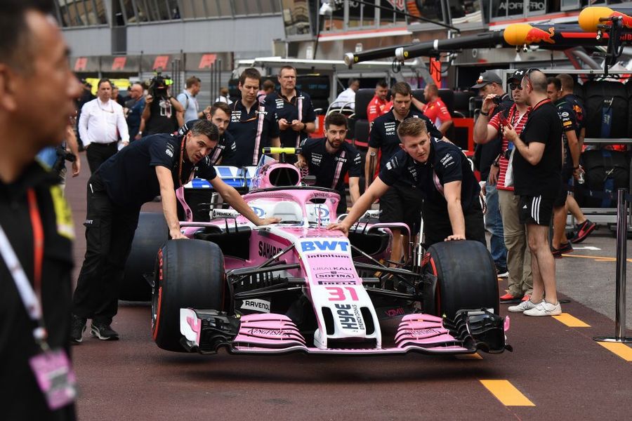 Force India mechanics push VJM11 in pit lane