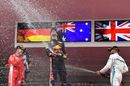 Race winner Daniel Ricciardo, Sebastian Vettel and Lewis Hamilton celebrates on the podium with the champagne