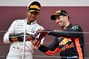 Lewis Hamilton pours champagne into the shoe of Race winner Daniel Ricciardo on the podium
