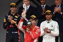 Sebastian Vettel kisses his trophy on the podium

