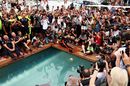 Race winner Daniel Ricciardo celebrates with a swan dive into the swimming pool