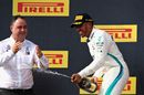 Race winner Lewis Hamilton celebrate on the podium with the champagne