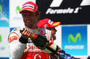 Jenson Button celebrates on the podium