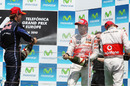 The top three spray champagne on the podium