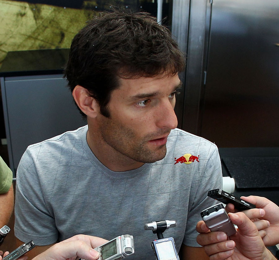 Mark Webber talks to the press after his crash