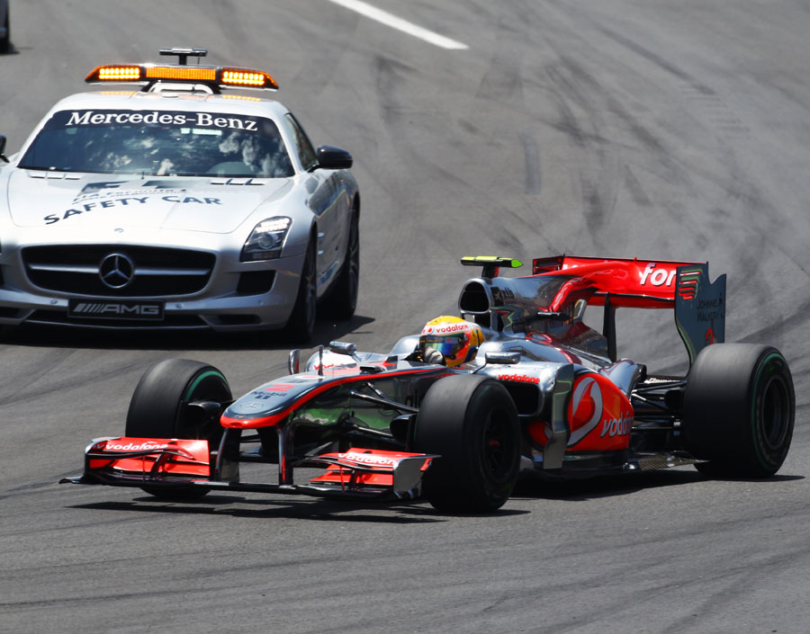 Lewis Hamilton overtakes the safety car as it joins the track