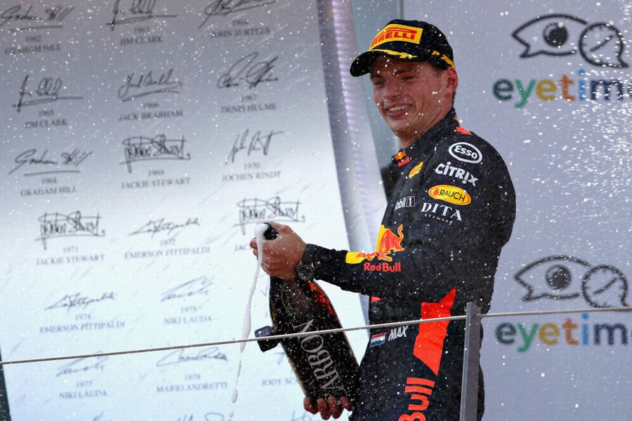 Race winner Max Verstappen celebrates on the podium with the champagne