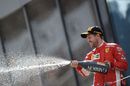 Sebastian Vettel cerebrates on the podium with the champagne