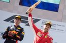 Sebastian Vettel cerebrates on the podium with the trophy