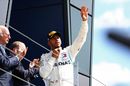 Lewis Hamilton cerebrates on the podium
