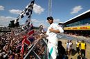 Lewis Hamilton greets the crowd after the raace