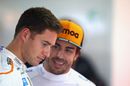 Stoffel Vandoorne talks with Fernando Alonso in the garage