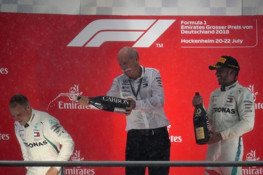 Race winner Lewis Hamilton and Valtteri Bottas celebrate on the podium with the champagne