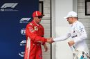 Kimi Raikkonen shakes hands with Valtteri Bottas in parc ferme